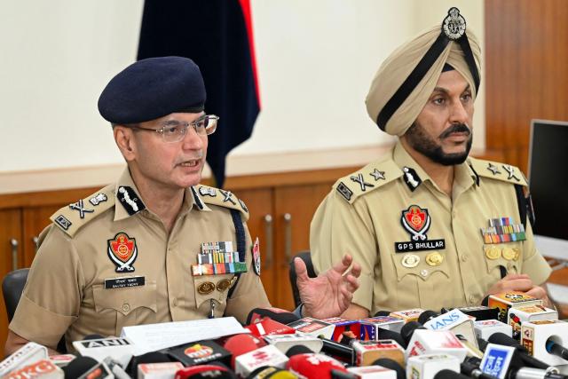 Gaurav Yadav (L), Punjab's Director General of Police (DGP) addresses a press conference after his visit to a blast site, the night after the explosion at the Army cantonment area on the outskirts of Amritsar on May 6, 2026. (Photo by Narinder NANU / AFP)