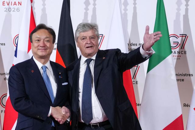 Japan's State Minister for Foreign Affairs Horii Iwao (L) is welcomed by France's Trade Minister Nicolas Forissier upon arrival for a meeting of the Trade Ministers of the G7 countries in preparation for the summit of heads of State and government to be held in June in Evian, in Paris on May 6, 2026. (Photo by Aurelien Morissard / POOL / AFP)