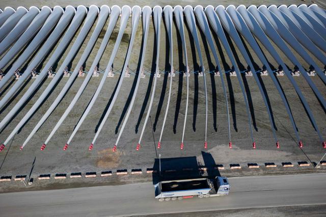 (FILES) An aerial view taken on October 15, 2024 shows wind turbine blades of Vestas, a global leader in sustainable energy solutions, located at the Port of Odense, Denmark. Denmark's Vestas, Europe's leading wind turbine manufacturer, on May 6, 2026 posted a net profit of 70 million euro ($82 million) for the first quarter, and said it had a "record" number of orders. (Photo by Jonathan NACKSTRAND / AFP)