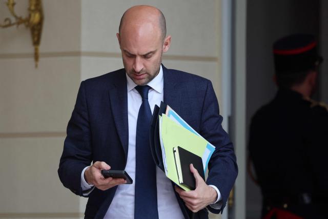 France's Foreign Affairs Minister Jean-Noel Barrot looks at his phone as he leaves after the weekly cabinet meeting at The Elysee Presidential Palace in Paris on May 6, 2026. (Photo by Ludovic MARIN / AFP)