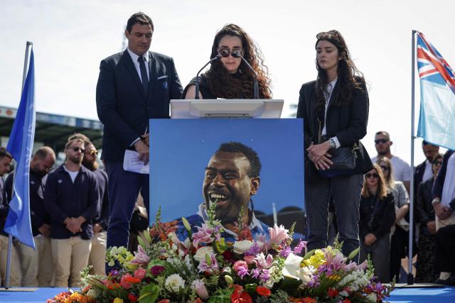 (FILES) Castres' Fiji wing Josaia Raisuqe's wife, Ilona (C) delivers a speecyh during a ceremony to pay tribute to the Castres Olympique's Fijian winger, at Stade Pierre Fabre, in Castres, southern France on May 10, 2025. "We dont forget, we live with it": a year after the sudden death of their Fijian three-quarter Josaia Raisuqe, Castres Olympique are still learning to cope with the loss, the trauma and the memory of a "radiant" man, whose death has left a lasting mark on the whole team. (Photo by Valentine CHAPUIS / AFP)