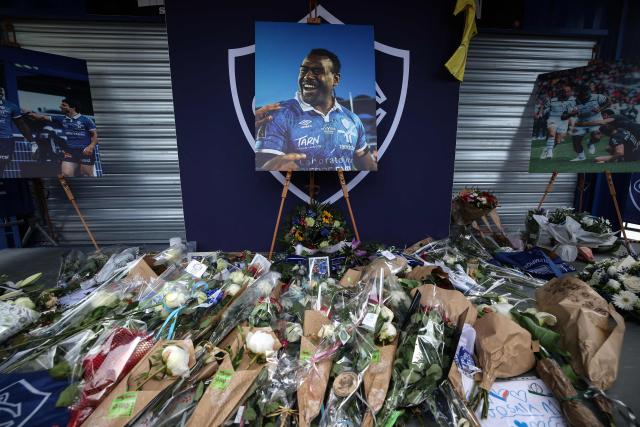 (FILES) This photograph shows a portrait of Castres Olympique's Fijian winger Josaia Raisuqe sorrounding by flowers during a ceremony to pay his tribute, at Stade Pierre Fabre, in Castres, southern France on May 10, 2025. "We dont forget, we live with it": a year after the sudden death of their Fijian three-quarter Josaia Raisuqe, Castres Olympique are still learning to cope with the loss, the trauma and the memory of a "radiant" man, whose death has left a lasting mark on the whole team. (Photo by Valentine CHAPUIS / AFP)