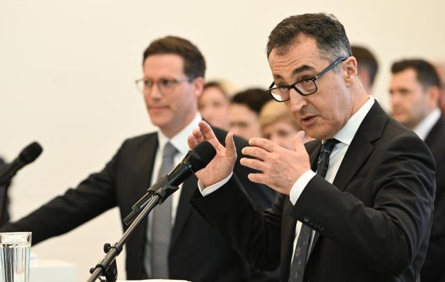Cem Oezdemir (R) of the Greens and Manuel Hagel, chairman of the Christian Democratic Union (CDU) party in the southern federal state of Baden-Wuerttemberg, address the press to present their coalition contract following the federal state's elections, in Stuttgart, southern Germany, on May 6, 2026. (Photo by THOMAS KIENZLE / AFP)
