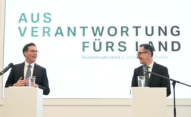Cem Oezdemir (R) of the Greens and Manuel Hagel, chairman of the Christian Democratic Union (CDU) party in the southern federal state of Baden-Wuerttemberg, address the press to present their coalition contract following the federal state's elections, in Stuttgart, southern Germany, on May 6, 2026. (Photo by THOMAS KIENZLE / AFP)