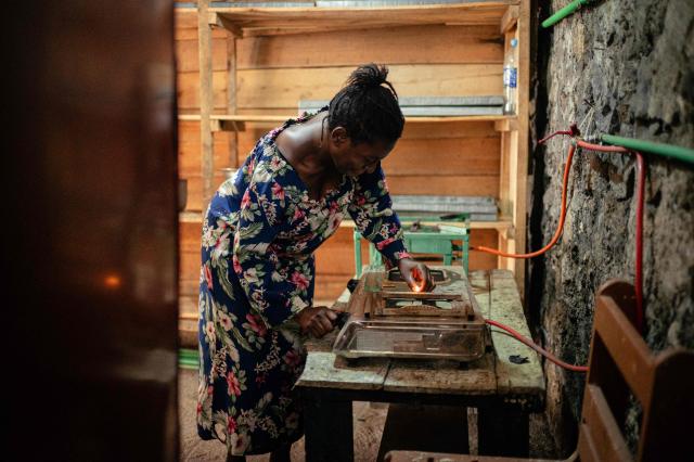 A woman uses biogas in her small bakery, notably to cook beans, in Goma on April 20, 2026. Most of the city's nearly one million people cannot afford to use electricity and mostly depend on charcoal, called makala, for cooking and heating.
Some people are switching to biogas, a renewable energy source that is cheaper and locally produced.
Biogas is produced by the decomposition of organic matter.
It has been made in Goma since 2016 by Umoja, a local company whose stated aim is to offer an alternative to firewood, which destroys forests. (Photo by Jospin Mwisha / AFP)