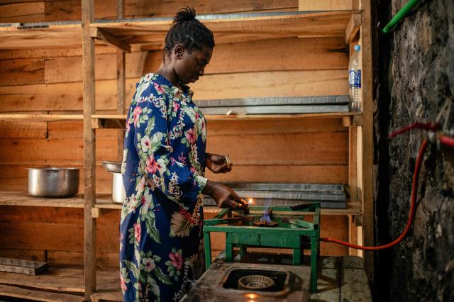 A woman uses biogas in her small bakery, notably to cook beans, in Goma on April 20, 2026. Most of the city's nearly one million people cannot afford to use electricity and mostly depend on charcoal, called makala, for cooking and heating.
Some people are switching to biogas, a renewable energy source that is cheaper and locally produced.
Biogas is produced by the decomposition of organic matter.
It has been made in Goma since 2016 by Umoja, a local company whose stated aim is to offer an alternative to firewood, which destroys forests. (Photo by Jospin Mwisha / AFP)