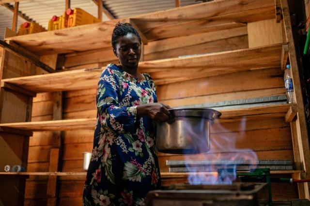 A woman uses biogas in her small bakery, notably to cook beans, in Goma on April 20, 2026. Most of the city's nearly one million people cannot afford to use electricity and mostly depend on charcoal, called makala, for cooking and heating.
Some people are switching to biogas, a renewable energy source that is cheaper and locally produced.
Biogas is produced by the decomposition of organic matter.
It has been made in Goma since 2016 by Umoja, a local company whose stated aim is to offer an alternative to firewood, which destroys forests. (Photo by Jospin Mwisha / AFP)