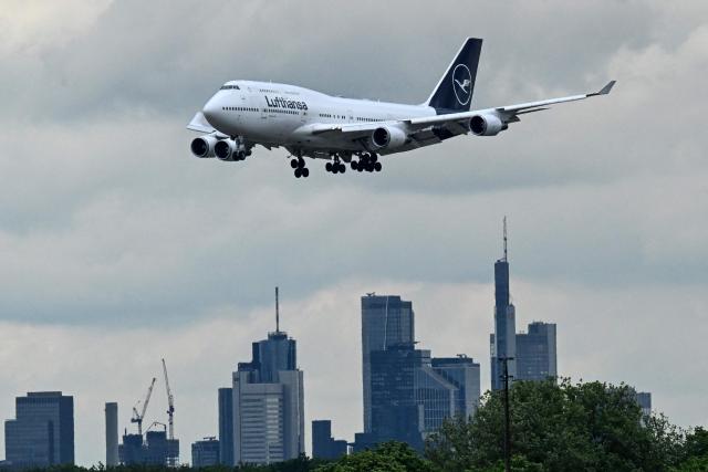 A Boeing 747-430 aircraft by German airline Lufthansa prepares to land backdropped by the skyline of Frankfurt am Main at the Frankfurt International Airport, Frankfurt am Main, western Germany, on May 6, 2026.  (Photo by Kirill KUDRYAVTSEV / AFP)