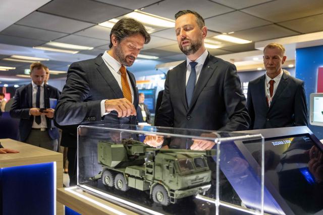 Poland's Deputy Prime Minister and Defence Minister Wladyslaw Kosiniak-Kamysz (C) and Slovakia's Deputy Prime Minister and Defence Minister Robert Kalinak (C-L) visit a stand of a Slovak arms company at the "Defence24 Days" – a conference on defence and security attended by various leaders and experts from the region, in Warsaw, Poland, on May 6, 2026. (Photo by Wojtek RADWANSKI / AFP)
