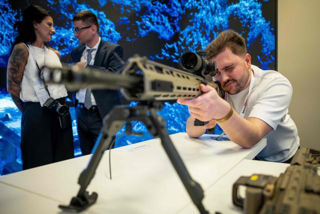 A man checks a rifle at the PGZ - Polska Grupa Zbrojeniowa (Polish Armaments Group) stand during the "Defence24 Days" – a conference on defence and security attended by various leaders and experts from the region, in Warsaw, Poland, on May 6, 2026. (Photo by Wojtek RADWANSKI / AFP)