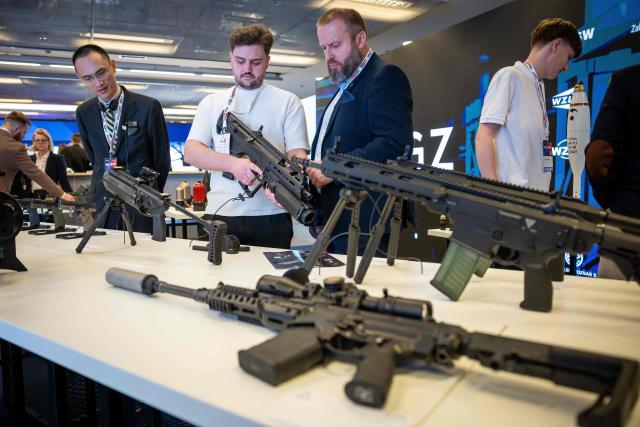 A man checks a rifle at the PGZ - Polska Grupa Zbrojeniowa (Polish Armaments Group) stand during the "Defence24 Days" – a conference on defence and security attended by various leaders and experts from the region, in Warsaw, Poland, on May 6, 2026. (Photo by Wojtek RADWANSKI / AFP)