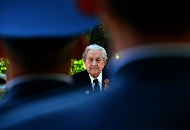 World War Two veteran Mikhail Sukhinin, 99, receives congratulations from Kyrgyz servicemen as part of the Victory Day celebrations in Bishkek on May 6, 2026. Kyrgyzstan will celebrate the 81st anniversary of the Soviet Union's victory over Nazi Germany on May 9. (Photo by Vyacheslav OSELEDKO / AFP)