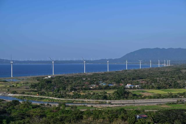 Wind turbines are pictured along the shore in Bangui in the northern Philippines province of Ilocos Norte on May 6, 2026. (Photo by Jam STA ROSA / AFP)