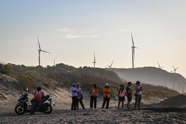 Wind turbines are pictured along the shore in Bangui in the northern Philippines province of Ilocos Norte on May 6, 2026. (Photo by Jam STA ROSA / AFP)