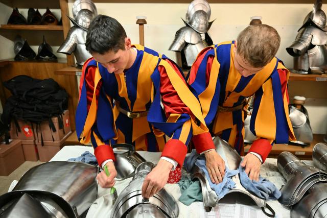 New Swiss Guards, responsible for protecting the pope, prepare their gear at the Vatican Armoury of the Pontifical Swiss Guard headquarters before the swearing-in ceremony of new Swiss Guard recruits at the Vatican, on May 6, 2026. (Photo by Alberto PIZZOLI / AFP)