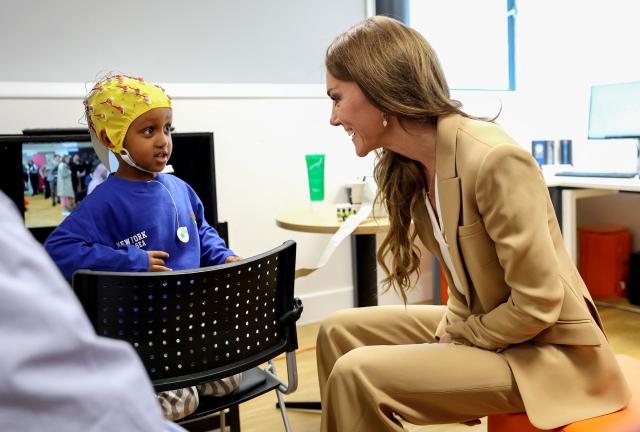 Britain's Catherine, Princess of Wales reacts speaks with Mikhail, aged 3, as she learns about pioneering state-of-the-art wearables and brain recording techniques during a visit to the University of East London in Stratford, east London, on May 6, 2026, to launch 'Foundations for Life: A Guide to Social and Emotional Development', as part of the Royal Foundation Centre for Early Childhood. (Photo by Chris Jackson / POOL / AFP) / The erroneous mention[s] appearing in the metadata of this photo by Chris Jackson has been modified in AFP systems in the following manner: [Mikhail, aged 3] instead of [Ella, aged 5]. Please immediately remove the erroneous mention[s] from all your online services and delete it (them) from your servers. If you have been authorized by AFP to distribute it (them) to third parties, please ensure that the same actions are carried out by them. Failure to promptly comply with these instructions will entail liability on your part for any continued or post notification usage. Therefore we thank you very much for all your attention and prompt action. We are sorry for the inconvenience this notification may cause and remain at your disposal for any further information you may require.