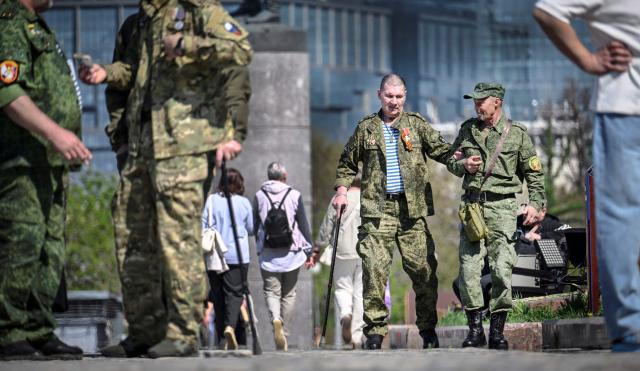 Russian veterans of the Russian-Ukrainian conflict walk outside the Museum of the Great Patriotic War (also known as the Victory Museum ) at Poklonnaya Hill in western Moscow on May 6, 2026, few days ahead of the Victory Day military parade, to be held at Red Square on May 9. Russia declared on May 4 a unilateral ceasefire with Ukraine between May 8-9, when Moscow marks its annual World War II Victory Day commemorations, and threatened a "massive missile strike" on Kyiv if Ukraine violated it. (Photo by Alexander NEMENOV / AFP)
