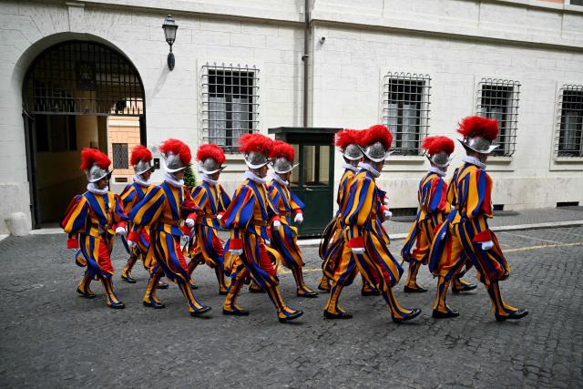 A picture shows picture shows Swiss Guards leaving their headquarters before the swearing-in ceremony of new Swiss Guard recruits at the Vatican, on May 6, 2026. (Photo by Alberto PIZZOLI / AFP)