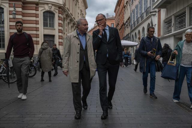 French politician and mayor of Le Havre Edouard Philippe (C-R) and mayor of Toulouse Jean-Luc Moudenc (C-L) walk along a street in Toulouse on May 6, 2026. Philippe, a candidate for the 2027 presidential election, is in Toulouse as part of a tour of France, with Moudenc among his key regional supporters. (Photo by Ed JONES / AFP)