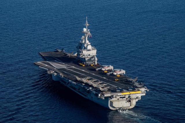 (FILES) This photograph taken on April 27, 2026, shows an aerial view of the French aircraft carrier Charles de Gaulle at the end of the NATO military exercise Neptune Strike 26-2, off the coast of the Greek island of Crete. France's aircraft carrier the Charles de Gaulle was on May 6, 2026,  heading towards the southern Red Sea to pre?position for a possible mission to restore navigation in the Strait of Hormuz, the presidency said. (Photo by Angelos TZORTZINIS / AFP)