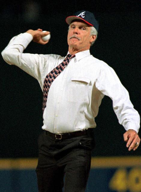 (FILES) Ted Turner, owner of the Atlanta Braves, throws the ceremonial first pitch before the first regular season game in the Braves new stadium, Turner Field  on April 4, 1997. CNN announced on May 6, 2026, that pioneering CNN founder Ted Turner has died at age 87. (Photo by STEVEN R. SCHAEFER / AFP)