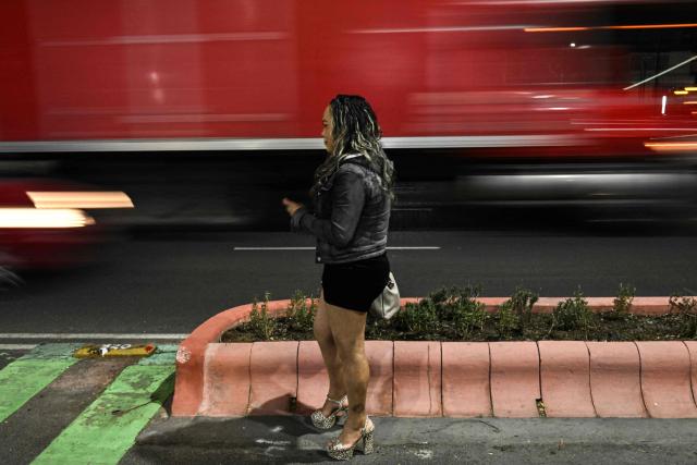 A sex worker who identified herself as Montserrat waits for clients at Tlalpan Avenue —which leads to the Banorte Stadium, the venue for the opening ceremony of the upcoming World Cup— in Mexico City on May 5, 2026. (Photo by Yuri CORTEZ / AFP)