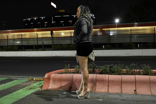 A sex worker who identified herself as Montserrat waits for clients at Tlalpan Avenue —which leads to the Banorte Stadium, the venue for the opening ceremony of the upcoming World Cup— in Mexico City on May 5, 2026. (Photo by Yuri CORTEZ / AFP)