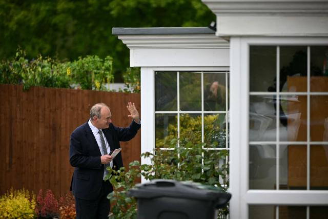 Britain's Liberal Democrat party leader Ed Davey speaks waves as the party canvases voters in Redhill, Surrey, south of London on May 6, 2026, a day before British local elections. British voters head to the polls on May 7 for local elections set to pile more misery on unpopular Labour Prime Minister Keir Starmer and cement the rise of right- and left-wing populists. (Photo by JUSTIN TALLIS / AFP)