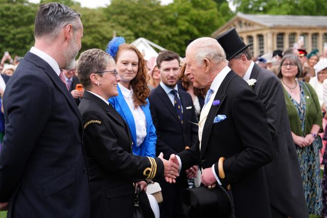 Britain's King Charles III talks to guests during a Royal Garden Party at Buckingham Palace, in London, on May 6, 2026. (Photo by Aaron Chown / POOL / AFP)
