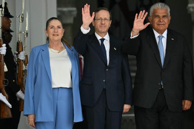 The President of Israel, Isaac Herzog (C), and his Panamanian counterpart, Jose Raul Mulino, wave next to Herzog's wife Michal Herzog (L), at the Las Garzas palace in Panama City on May 6, 2026. Herzog is on an official visit aimed at strengthening cooperation and friendship between both countries. (Photo by MARTIN BERNETTI / AFP)