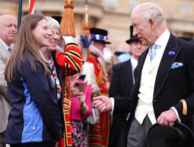 Britain's King Charles III talks to Amy Solomons from GirlGuiding as he meets guests during a Royal Garden Party at Buckingham Palace, in London, on May 6, 2026. (Photo by Aaron Chown / POOL / AFP)