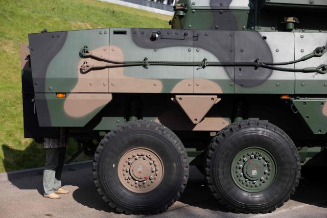 A visitor looks inside a Polish-made "Rosomak" APC (Armored Personnel Carrier) at the Exhibition of the Polish Armed Forces and the Polish Defence Industry during the "Defence24 Days" – a conference on defence and security attended by various leaders and experts from the region, in Warsaw, Poland, on May 6, 2026. (Photo by Wojtek RADWANSKI / AFP)