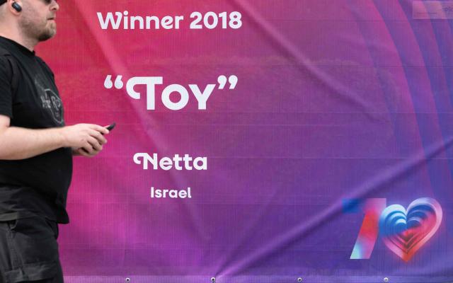 A fence around the fan zone of the 2026 Eurovision Song Contest, with a banner showing the name of the 2018 contest winner, Netta from Israel, is pictured outside the Wiener Stadthalle in Vienna, Austria on May 6, 2026. (Photo by Joe Klamar / AFP)