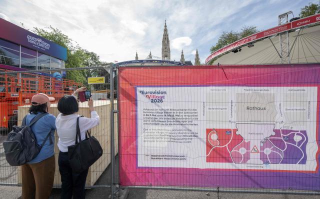 Tourists take pictures of the fan zone, during preparations of the 2026 Eurovision Song Contest, outside the Wiener Stadthalle, in Vienna, Austria on May 6, 2026. (Photo by Joe Klamar / AFP)