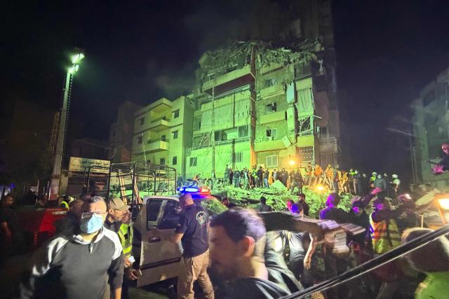 People gather at the site of an Israeli airstrike that targeted Beirut’s southern suburbs Haret Hreik neighborhood on May 6, 2026. An Israeli strike in Lebanon's eastern Bekaa valley killed four people on May 6, while the Israeli army said it struck Hezbollah targets in the south, after warning residents of a dozen towns to evacuate. Israel and Hezbollah have been trading accusations of violating the ceasefire agreement in force since April 17. (Photo by Ibrahim AMRO / AFP)