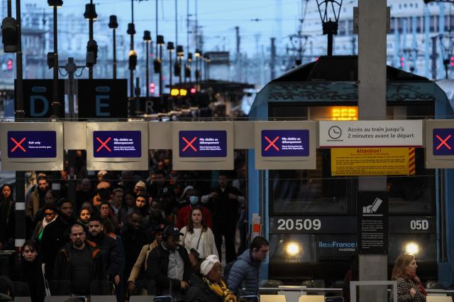 (FILES) Passengers walk on a platform at the Gare de Lyon train station amid a ticket controller strike in Paris on February 16, 2024. The four representative unions at SNCF announced on May 6, 2026 a joint call for a strike on June 10, to protest against the rail group’s "reorganizations," which are causing "human tragedies" among railway workers. (Photo by Ian LANGSDON / AFP)