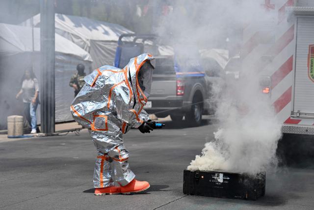 A rescue team member uses pollutant-measuring equipment during a simulated chemical-biological gas leak during an earthquake drill in Mexico City on May 6, 2026. (Photo by Yuri CORTEZ / AFP)