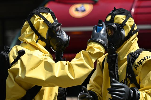 Mexican Army rescue teams use pollutant-measuring equipment during a simulated chemical-biological gas leak during an earthquake drill in Mexico City on May 6, 2026. (Photo by Yuri CORTEZ / AFP)