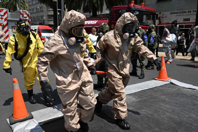 Rescue teams of the Mexican Navy and Army evacuate a simulated victim from a supposedly collapsed building at the Plaza del Monumento a la Revolucion during an earthquake drill in Mexico City on May 6, 2026. (Photo by Yuri CORTEZ / AFP)
