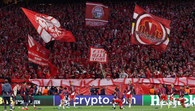 Bayern Munich fans cheer as their team (Bottom) warms up prior to the start of the UEFA Champions League second-leg, semi-final football match between FC Bayern Munich and Paris Saint-Germain (PSG) in Munich, southern Germany on May 6, 2026. (Photo by FRANCK FIFE / AFP)