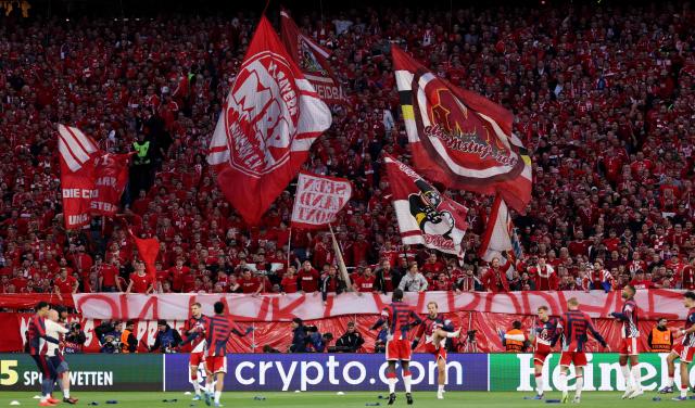 Bayern Munich fans cheer as their team (Bottom) warms up prior to the start of the UEFA Champions League second-leg, semi-final football match between FC Bayern Munich and Paris Saint-Germain (PSG) in Munich, southern Germany on May 6, 2026. (Photo by FRANCK FIFE / AFP)