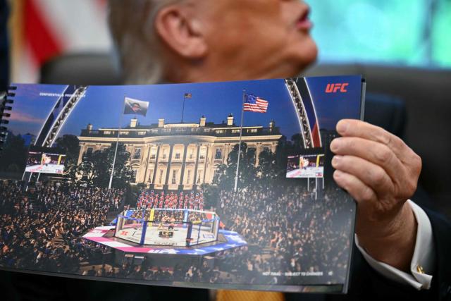 US President Donald Trump shows a rendering of the upcoming "UFC Freedom 250" event as he speaks in the Oval Office of the White House on May 6, 2026, in Washington, DC. An Ultimate Fighting Championship event will be staged on the White House's South Lawn in June. The June 14 event has been dubbed "UFC Freedom 250," in reference to the United States' 250th anniversary celebrations this summer. (Photo by Kent NISHIMURA / AFP)