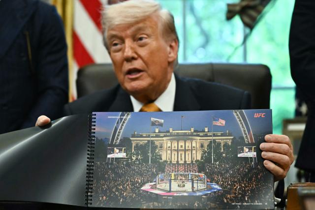 US President Donald Trump shows a rendering of the upcoming "UFC Freedom 250" event as he speaks in the Oval Office of the White House on May 6, 2026, in Washington, DC. An Ultimate Fighting Championship event will be staged on the White House's South Lawn in June. The June 14 event has been dubbed "UFC Freedom 250," in reference to the United States' 250th anniversary celebrations this summer. (Photo by Kent NISHIMURA / AFP)