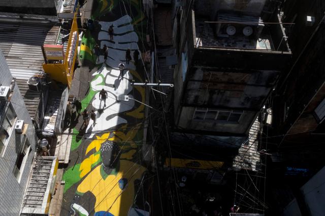 Aerial view of one of the main entrance streets to the Rocinha favela, decorated ahead of the 2026 FIFA World Cup, in Rio de Janeiro, Brazil, on May 6, 2026. (Photo by Pablo PORCIUNCULA / AFP)