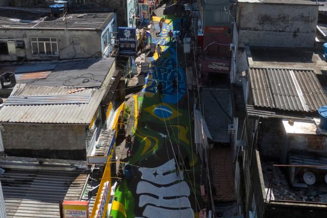 Aerial view of one of the main entrance streets to the Rocinha favela, decorated ahead of the 2026 FIFA World Cup, in Rio de Janeiro, Brazil, on May 6, 2026. (Photo by Pablo PORCIUNCULA / AFP)
