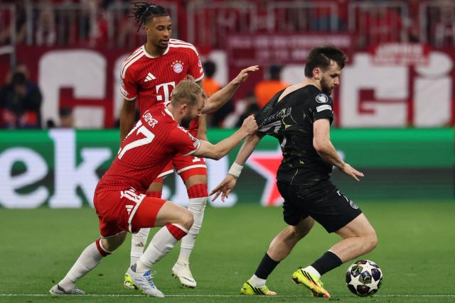 (From L) Bayern Munich's French midfielder #17 Michael Olise, Bayern Munich's Austrian midfielder #27 Konrad Laimer and Paris Saint-Germain's Georgian forward #07 Khvicha Kvaratskhelia vie for the ball during the UEFA Champions League second-leg, semi-final football match between FC Bayern Munich and Paris Saint-Germain (PSG) in Munich, southern Germany on May 6, 2026. (Photo by FRANCK FIFE / AFP)