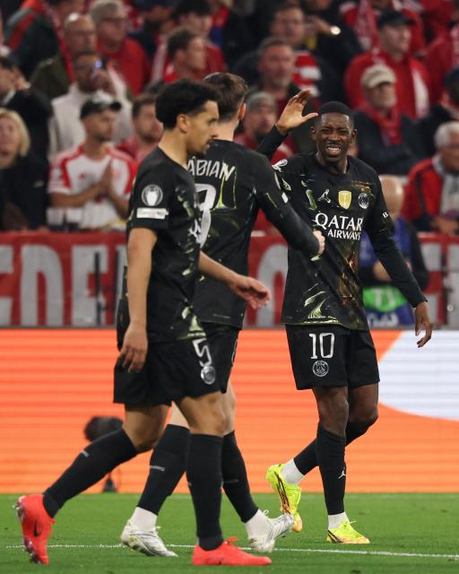 Paris Saint-Germain's French forward #10 Ousmane Dembele (R) celebrates scoring his team's first goal with Paris Saint-Germain's Brazilian defender #05 Marquinhos during the UEFA Champions League second-leg, semi-final football match between FC Bayern Munich and Paris Saint-Germain (PSG) in Munich, southern Germany on May 6, 2026. (Photo by FRANCK FIFE / AFP)