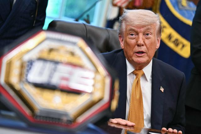 A UFC championship belt is displayed as US President Donald Trump speaks about the upcoming "UFC Freedom 250" event, in the Oval Office of the White House on May 6, 2026, in Washington, DC. An Ultimate Fighting Championship event will be staged on the White House's South Lawn in June. The June 14 event has been dubbed "UFC Freedom 250," in reference to the United States' 250th anniversary celebrations this summer. (Photo by Kent NISHIMURA / AFP)