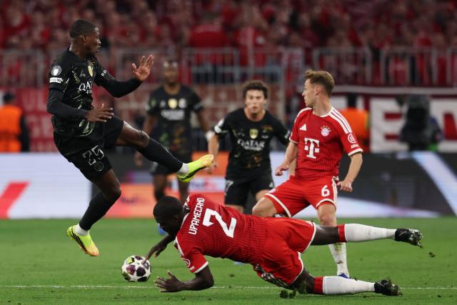 (From L) Paris Saint-Germain's Portuguese defender #25 Nuno Mendes, Bayern Munich's French defender #02 Dayot Upamecano and Bayern Munich's German midfielder #06 Joshua Kimmich vie for the ball during the UEFA Champions League second-leg, semi-final football match between FC Bayern Munich and Paris Saint-Germain (PSG) in Munich, southern Germany on May 6, 2026. (Photo by FRANCK FIFE / AFP)