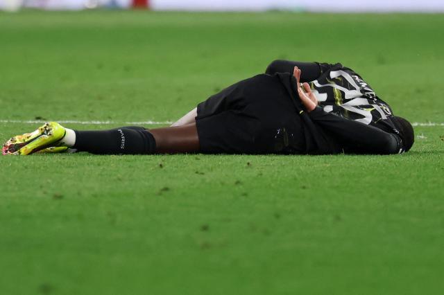 Paris Saint-Germain's Portuguese defender #25 Nuno Mendes reacts on the pitch during the UEFA Champions League second-leg, semi-final football match between FC Bayern Munich and Paris Saint-Germain (PSG) in Munich, southern Germany on May 6, 2026. (Photo by FRANCK FIFE / AFP)